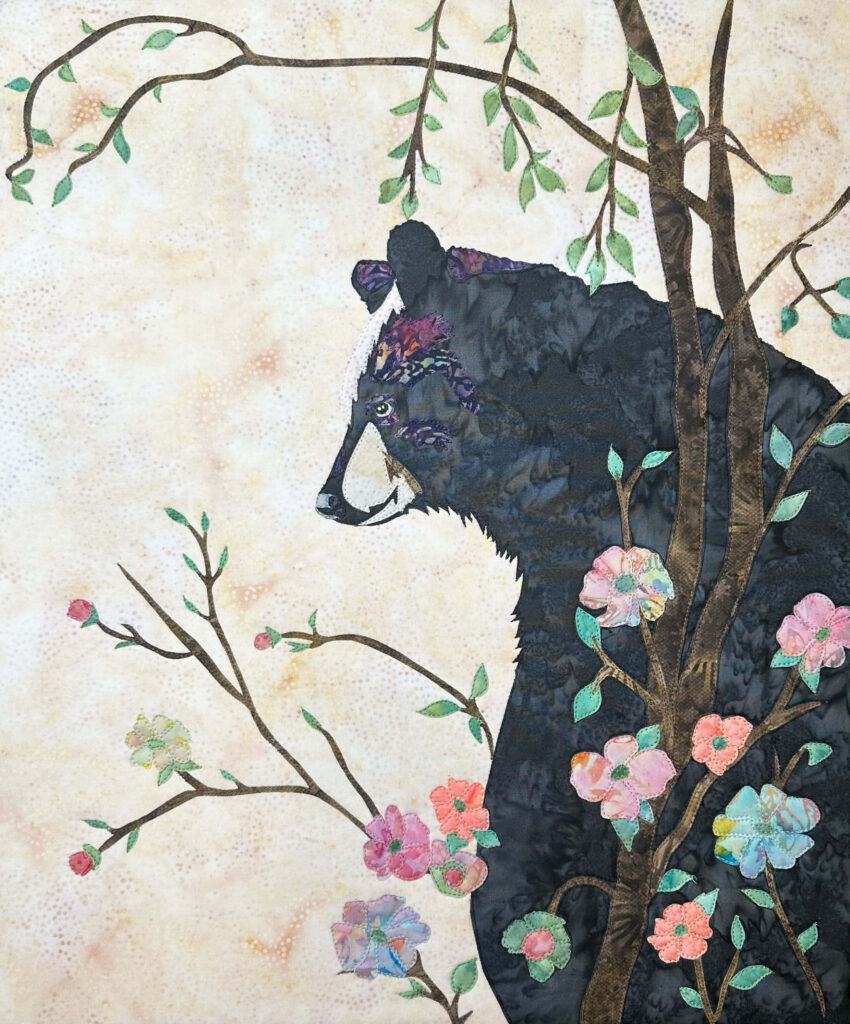 Flower Girl - Black Bear sitting among flowers